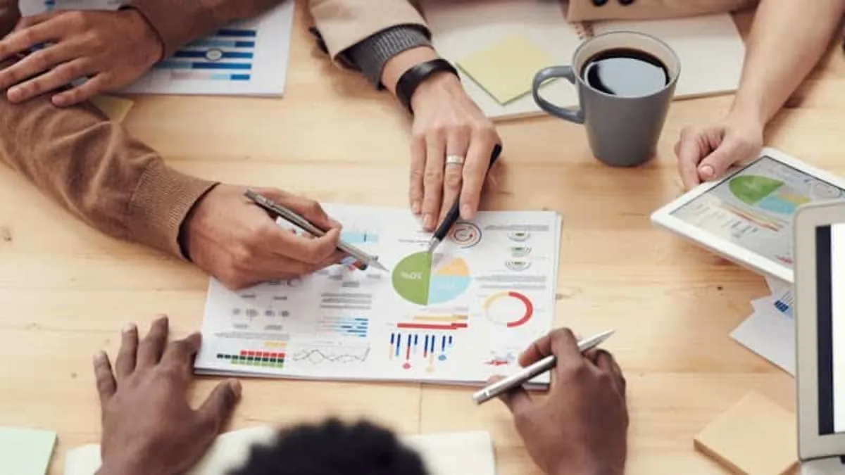 Business professional reviewing invoice documentation at a desk